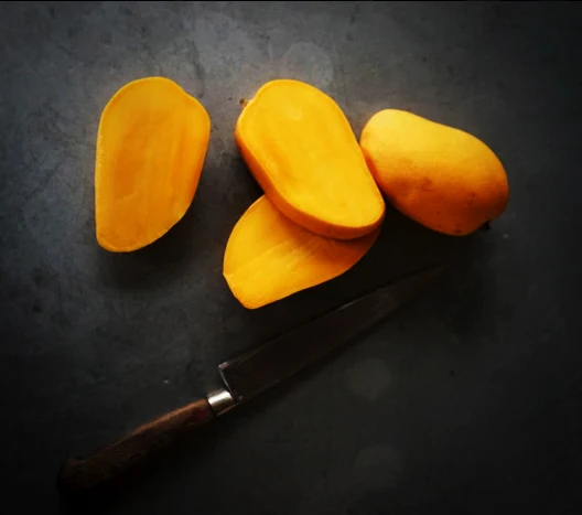 Whole and cut golden Ataulfo mangoes